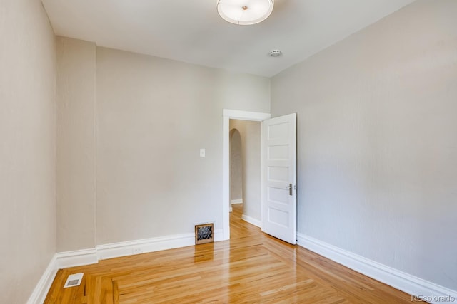 empty room with hardwood / wood-style floors