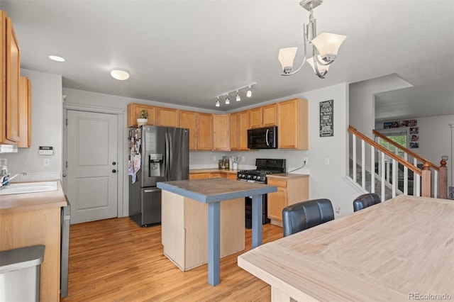 9272 E 108th Ave, Commerce City, CO 80640 - kitchen featuring black microwave, stainless steel fridge with ice dispenser, gas range, light wood finished floors, and a center island