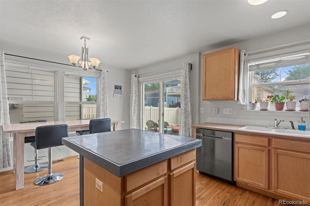 9272 E 108th Ave, Commerce City, CO 80640 - kitchen with dishwasher, light wood-type flooring, a kitchen island, a chandelier, and hanging light fixtures