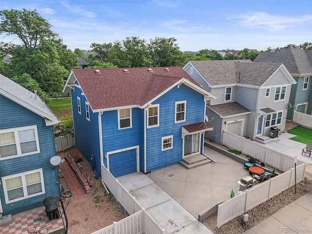 9272 E 108th Ave, Commerce City, CO 80640 - rear view of property with an attached garage, a fenced backyard, a patio, a shingled roof, and concrete driveway