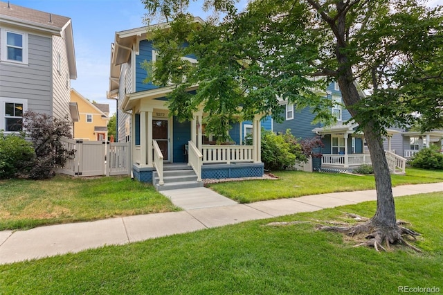9272 E 108th Ave, Commerce City, CO 80640 - view of front facade with a porch, a front lawn, and a gate