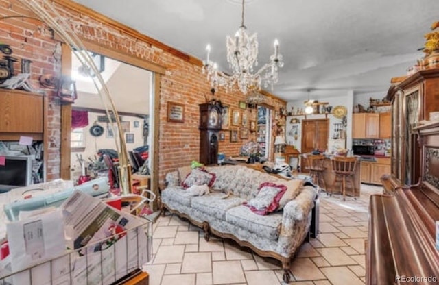 living room with brick wall and an inviting chandelier