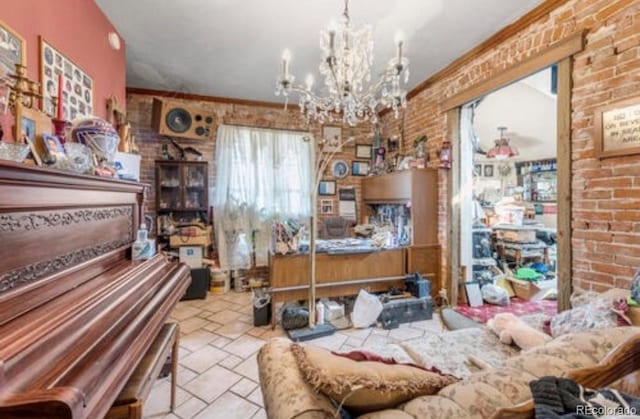 miscellaneous room featuring brick wall, crown molding, and an inviting chandelier