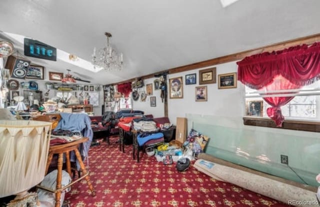 carpeted dining space featuring a chandelier and lofted ceiling