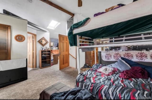 bedroom featuring ceiling fan, vaulted ceiling with beams, and carpet