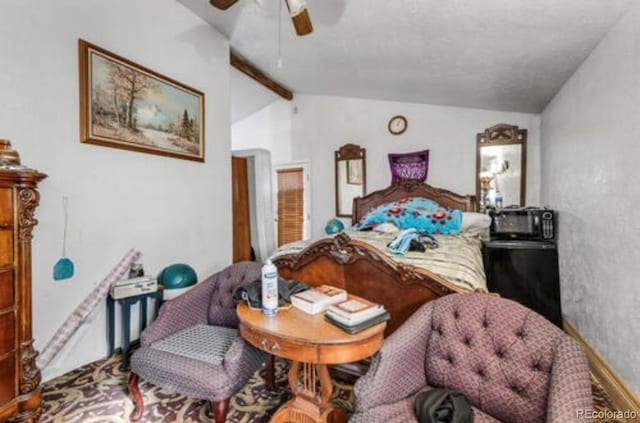 bedroom with ceiling fan and vaulted ceiling with beams