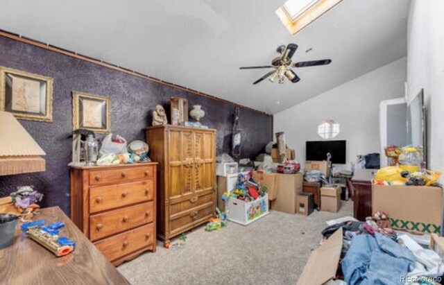 bedroom featuring ceiling fan, light carpet, and lofted ceiling with skylight