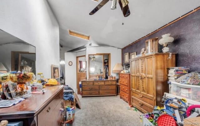 carpeted bedroom featuring lofted ceiling and ceiling fan