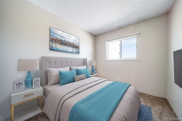 bedroom with carpet and a textured ceiling