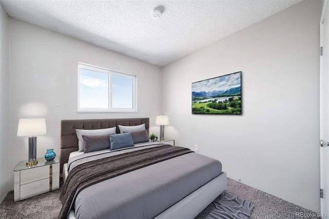 bedroom with a textured ceiling and carpet flooring