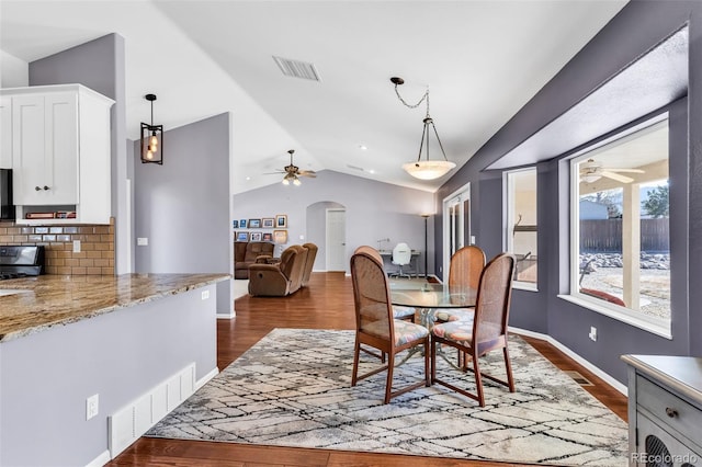 dining room featuring lofted ceiling, dark wood-type flooring, and ceiling fan