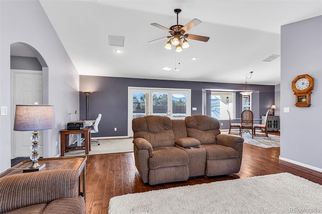 living room with vaulted ceiling, dark hardwood / wood-style floors, and ceiling fan