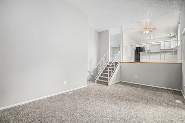 3246 S Nucla St, Aurora, CO 80013 - empty room featuring carpet floors, a ceiling fan, and stairs