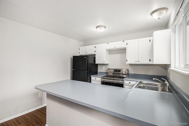 3246 S Nucla St, Aurora, CO 80013 - kitchen featuring stainless steel electric range oven, freestanding refrigerator, a peninsula, white cabinets, and dark wood-type flooring