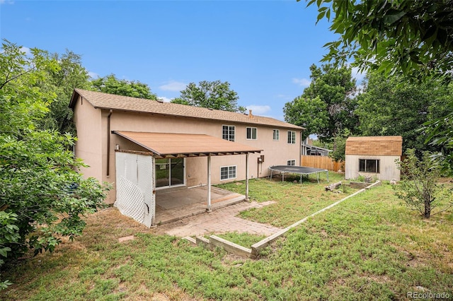3246 S Nucla St, Aurora, CO 80013 - back of house featuring a patio, stucco siding, a storage shed, and a trampoline
