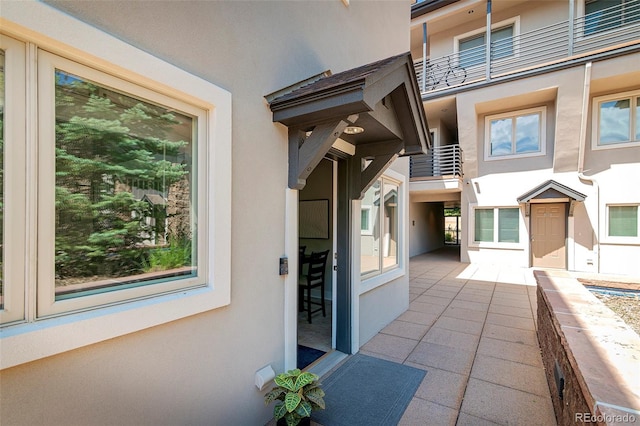 2800 Aurora Ave Unit 121, Boulder, CO 80303 - view of exterior entry with stucco siding and a balcony
