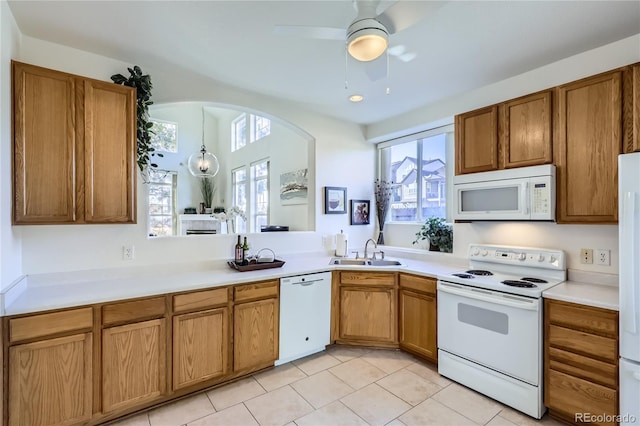 kitchen with sink, white appliances, ceiling fan, and light tile patterned floors