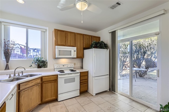 kitchen with sink, white appliances, ceiling fan, and light tile patterned floors