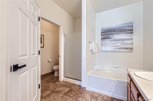 full bathroom featuring toilet, independent shower and bath, and vanity