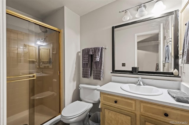 full bath with vanity, a stall shower, and toilet