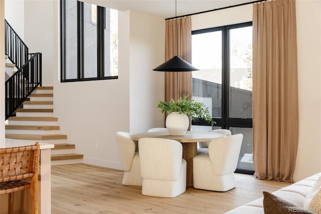 dining space with light hardwood / wood-style flooring