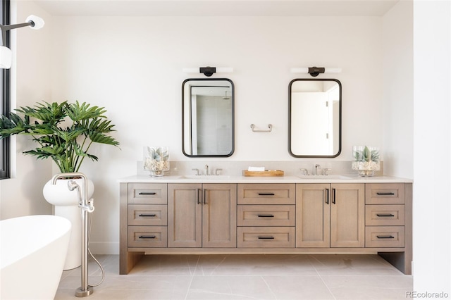 bathroom with a washtub, vanity, and tile patterned floors