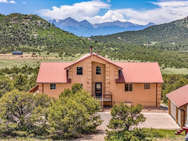 90 Riggs Rd, Westcliffe, CO 81252 - view of front of property with a mountain view, a metal roof, stucco siding, and an outbuilding