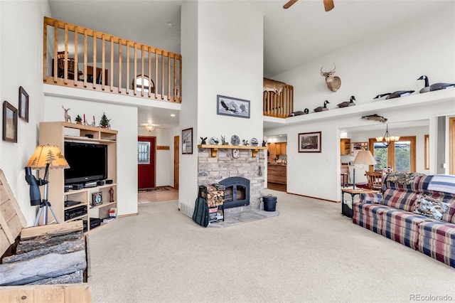 90 Riggs Rd, Westcliffe, CO 81252 - carpeted living room featuring a high ceiling, ceiling fan, a fireplace, and a chandelier