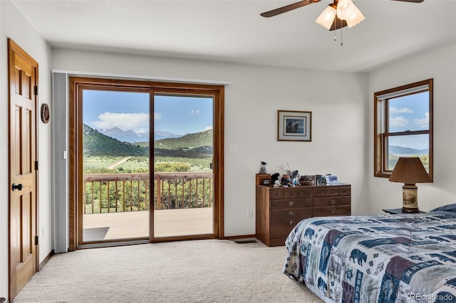 90 Riggs Rd, Westcliffe, CO 81252 - bedroom featuring access to exterior, carpet floors, a mountain view, and a ceiling fan