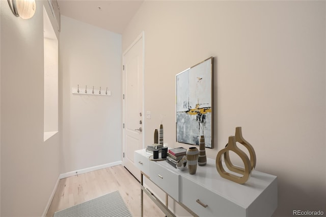 interior space featuring light wood-type flooring and baseboards