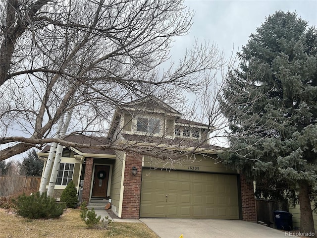 traditional-style house with a garage, brick siding, fence, and driveway