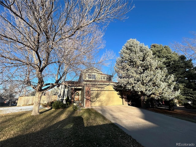 view of front of house featuring driveway, an attached garage, and brick siding