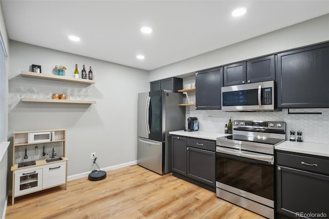 kitchen with open shelves, light countertops, tasteful backsplash, and stainless steel appliances