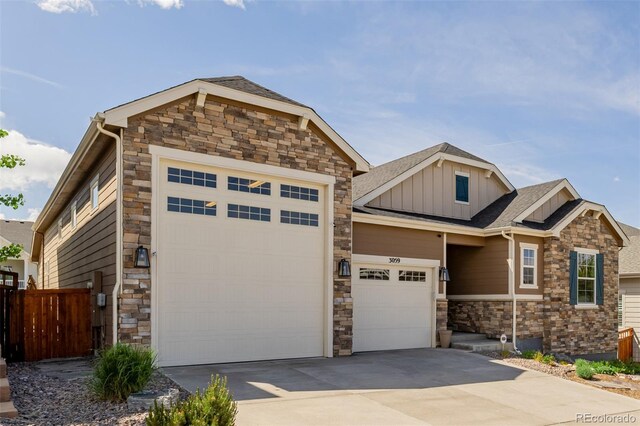 3059 Morningbird Ln, Castle Rock, CO 80109 - craftsman house featuring board and batten siding, driveway, stone siding, a garage, and a shingled roof