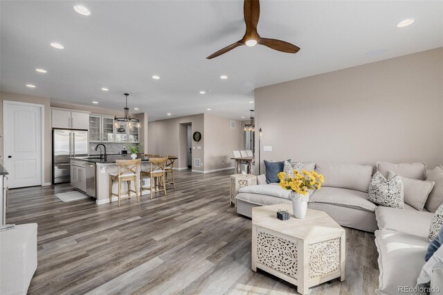 3059 Morningbird Ln, Castle Rock, CO 80109 - living area featuring recessed lighting, wood finished floors, a ceiling fan, and baseboards