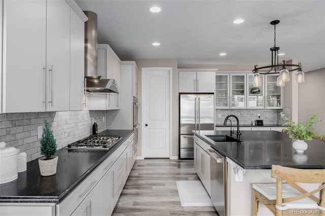 3059 Morningbird Ln, Castle Rock, CO 80109 - kitchen featuring a sink, stainless steel appliances, dark countertops, wall chimney range hood, and recessed lighting