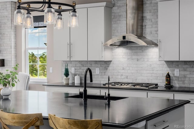 3059 Morningbird Ln, Castle Rock, CO 80109 - kitchen with wall chimney exhaust hood, dark countertops, stainless steel gas cooktop, and tasteful backsplash
