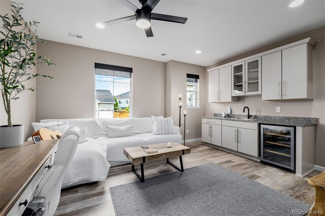 3059 Morningbird Ln, Castle Rock, CO 80109 - living area featuring beverage cooler, recessed lighting, ceiling fan, light wood-type flooring, and baseboards