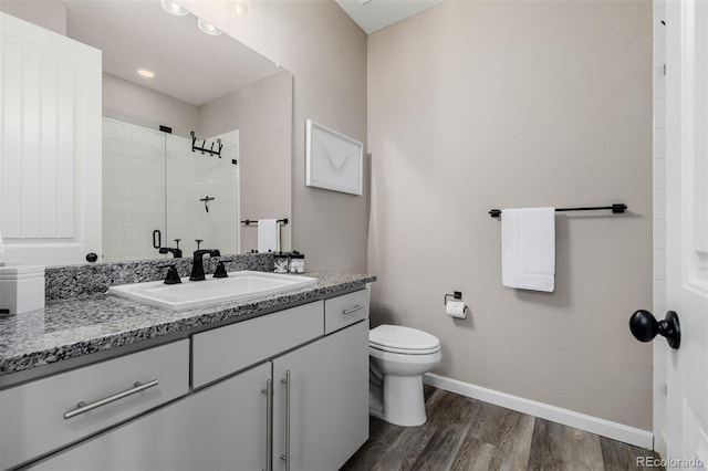 3059 Morningbird Ln, Castle Rock, CO 80109 - bathroom featuring wood finished floors, vanity, toilet, tiled shower, and baseboards