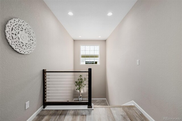 3059 Morningbird Ln, Castle Rock, CO 80109 - stairs featuring wood finished floors, baseboards, a textured wall, and recessed lighting