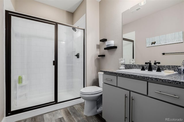 3059 Morningbird Ln, Castle Rock, CO 80109 - full bath with vanity, toilet, wood finished floors, and a shower stall