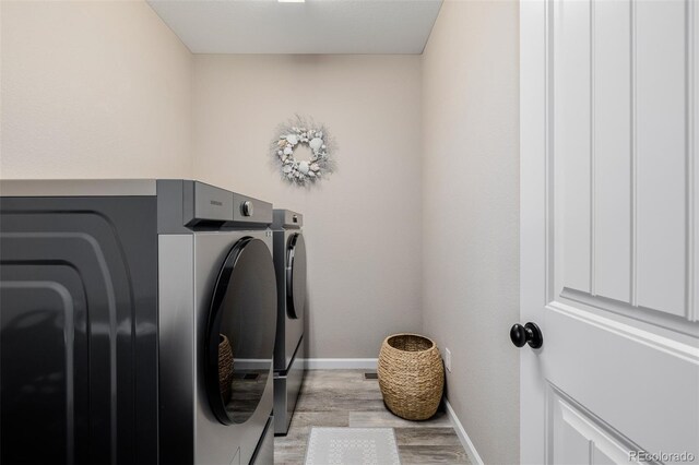 3059 Morningbird Ln, Castle Rock, CO 80109 - laundry area with separate washer and dryer, light wood-style flooring, and baseboards