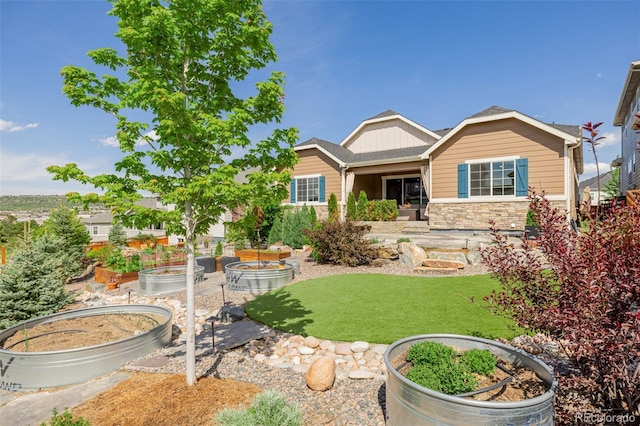 3059 Morningbird Ln, Castle Rock, CO 80109 - view of front of property with a garden, stone siding, and a front yard