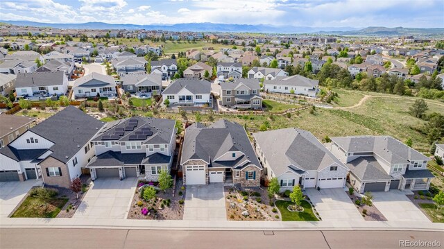 3059 Morningbird Ln, Castle Rock, CO 80109 - aerial perspective of suburban area with a mountainous background