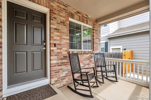 7472 S Memphis St, Aurora, CO 80016 - doorway to property featuring a porch and brick siding