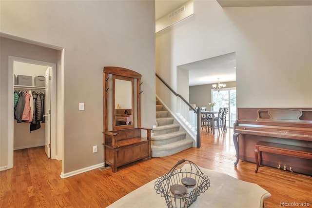 7472 S Memphis St, Aurora, CO 80016 - entrance foyer with wood finished floors, a chandelier, stairs, and baseboards