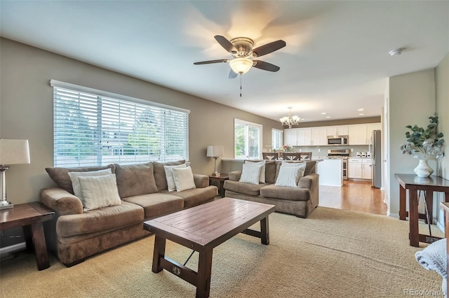 7472 S Memphis St, Aurora, CO 80016 - living area featuring a ceiling fan, light colored carpet, and a chandelier