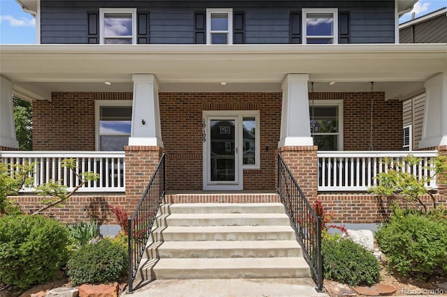 10109 E 28th Ave, Denver, CO 80238 - view of exterior entry featuring a porch and brick siding