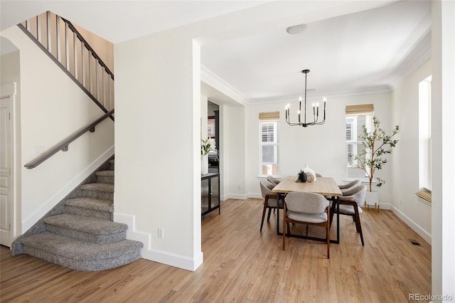 10109 E 28th Ave, Denver, CO 80238 - dining space with stairs, a chandelier, light wood-style flooring, baseboards, and ornamental molding