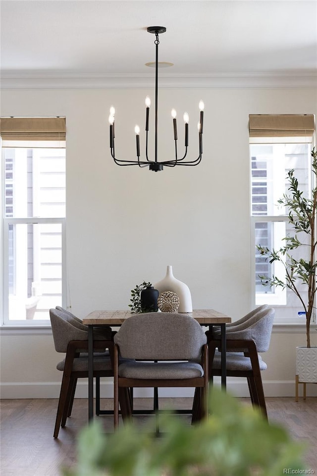 10109 E 28th Ave, Denver, CO 80238 - dining room featuring healthy amount of natural light, a chandelier, baseboards, and crown molding